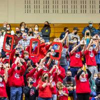 A team in the stands cheer on their robot